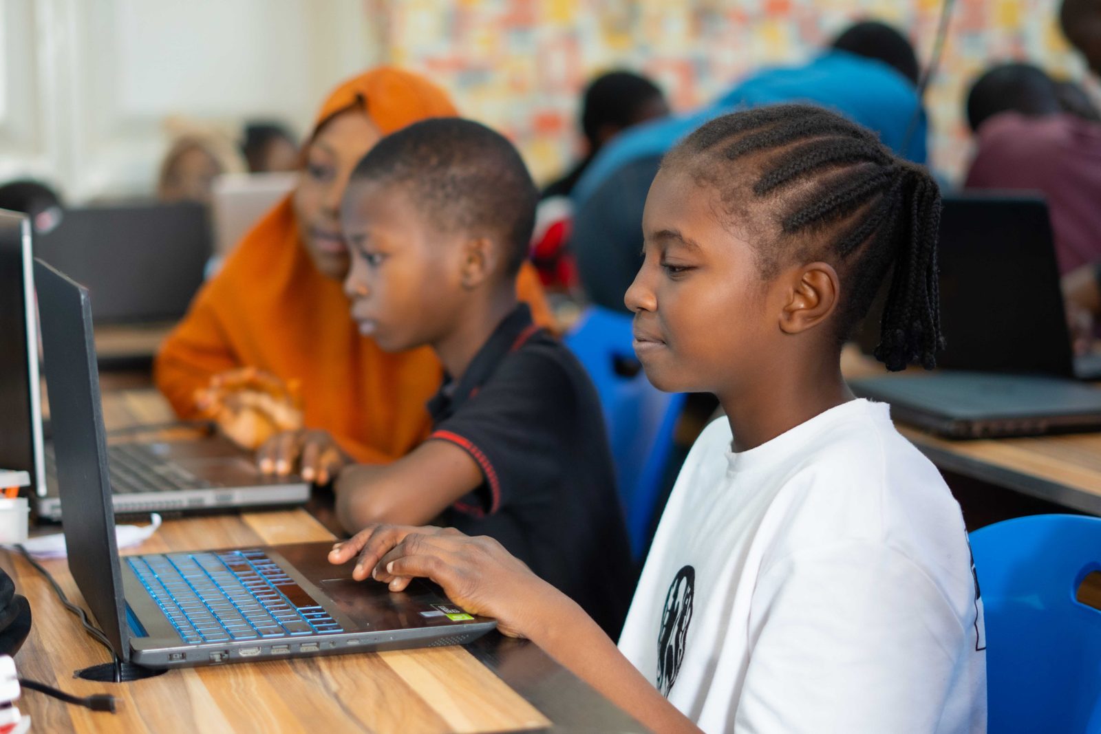Students learning to code on laptops in class